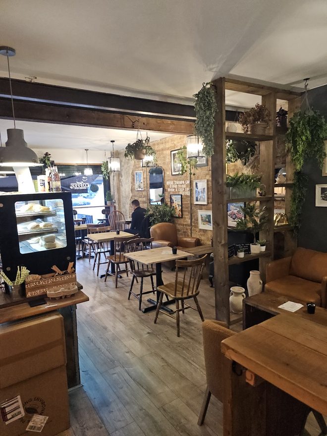 A view across the cafe past the chilled cake cabinet towards the tables