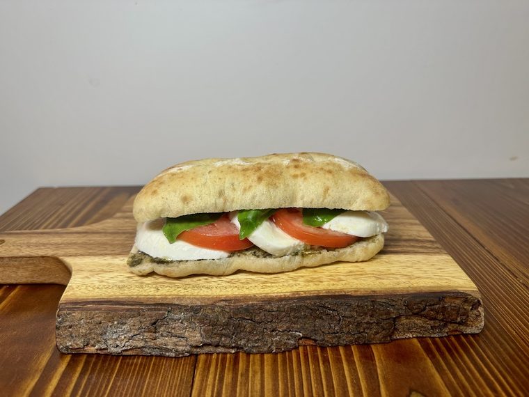 Mozzarella and tomato ciabatta on a wooden board